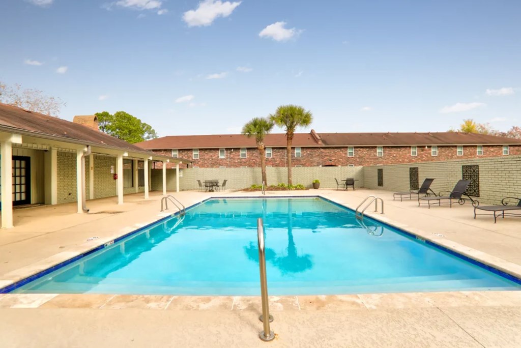A large swimming pool in front of a building.
